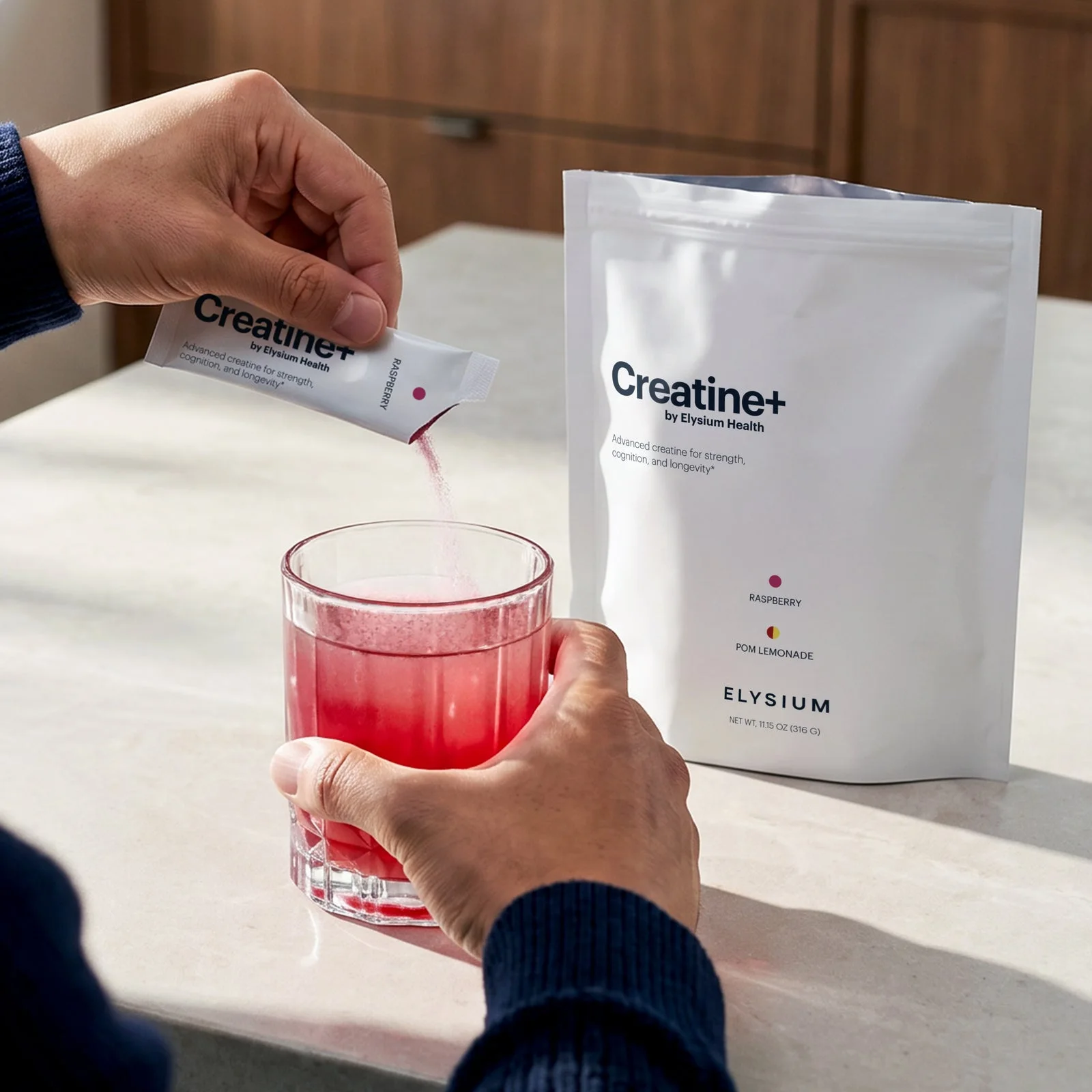 Creatine+ being poured from a daily stick into a glass of water